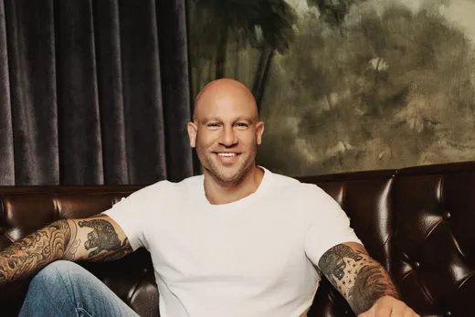Jeff Halevy seated on a leather banquette, smiling