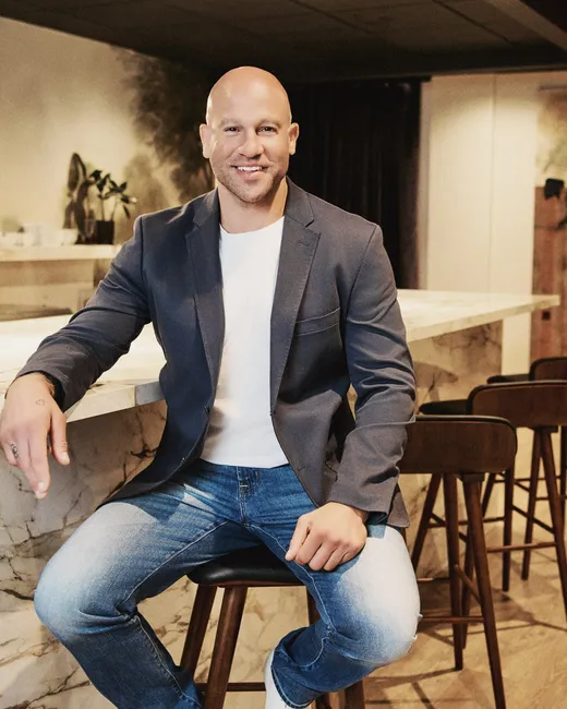 Jeff Halevy in a charcoal blazer at a marble bar