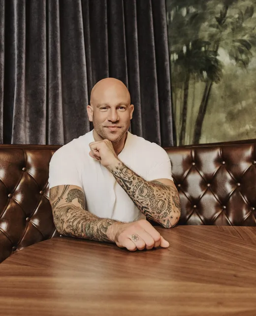 Jeff Halevy seated in a leather booth, smiling